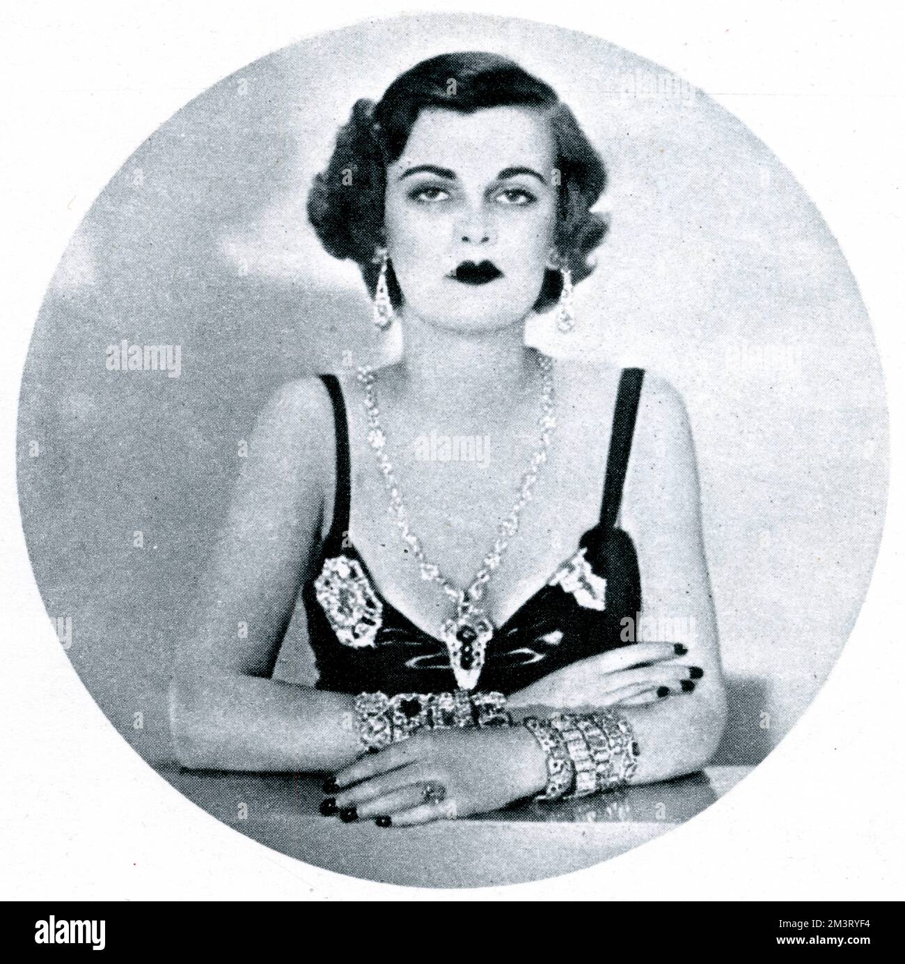 Miss Margaret Whigham, celebrated debutante and 'it' girl, later Mrs Charles Sweeny and then the Duchess of Argyll, whose divorce case in 1963 scandalised the country, pictured as 'The Precious One' in the Lovelies Parade at the Gay Party at the Café de Paris on 15 December 1932.      Date: 1932 Stock Photo