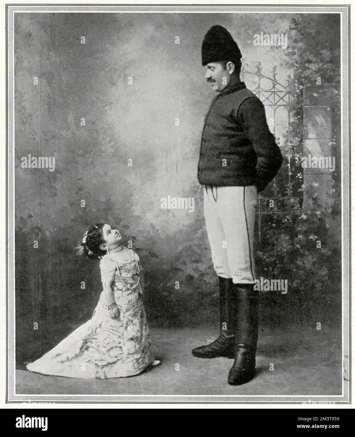 Mlle. Anita, measuring about twenty-six inches in height, and known as The Doll Lady or the Living Doll, pictured with her ordinary-sized brother, Herr Ignatz Zachowly during a visit to England.      Date: 1911 Stock Photo