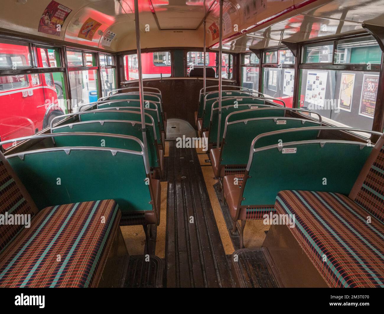 Seating area downstairs inside a 1952 AEC Regent III  London Transport green bus, London Bus Museum, part of Brooklands Museum, Surrey, UK. Stock Photo