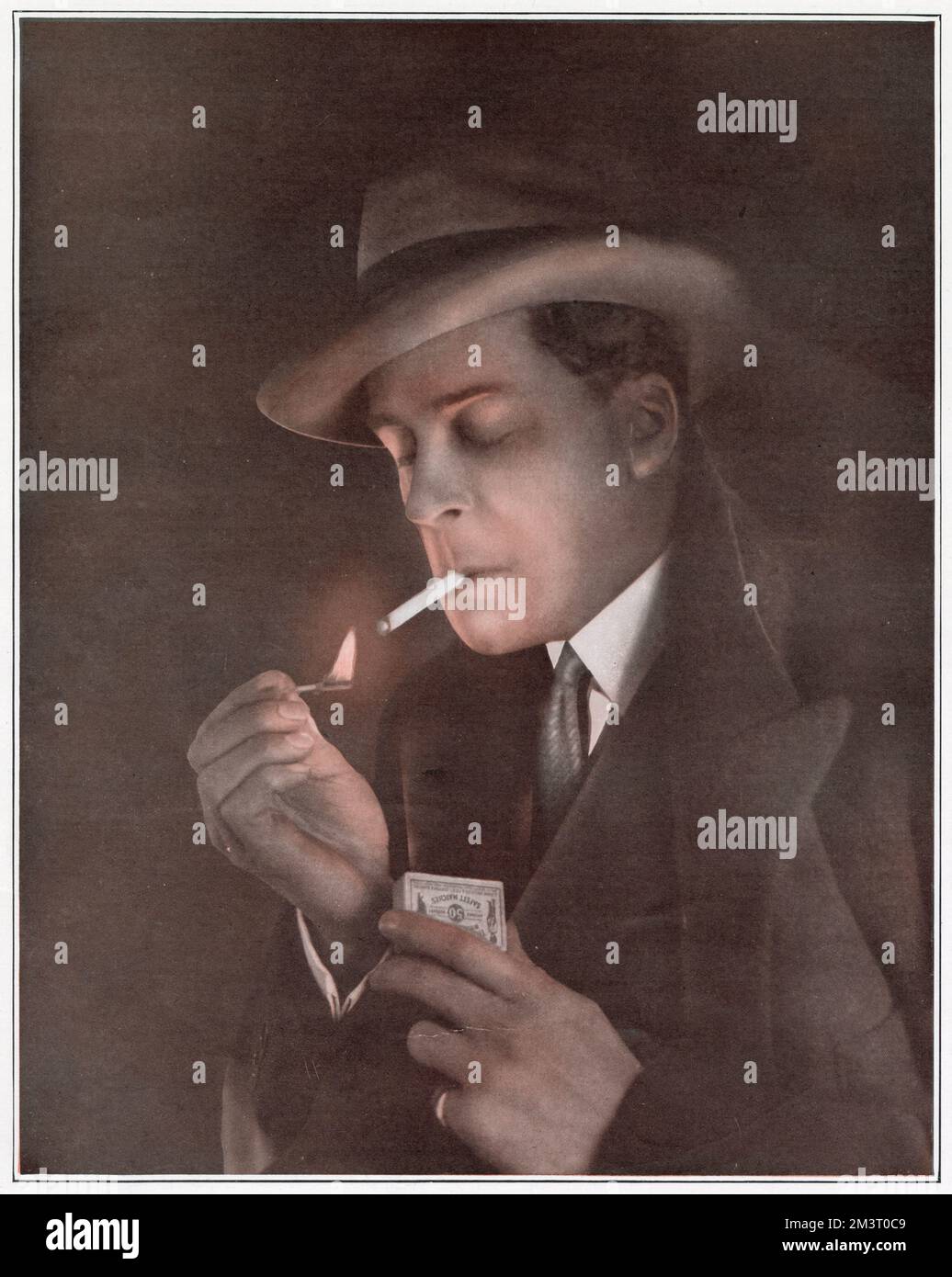 Jack Buchanan (1890 - 1957), Scottish theatre and film actor, singer, dancer, producer and director. Pictured smoking in a page from The Sketch that reported on the fact that in order to avoid hefty entertainment tax, the Shaftesbury Theatre was admitting the audience via boxes of chocolates or cigarettes, 'as a gesture against severe cabaret competition.'     Date: 1924 Stock Photo