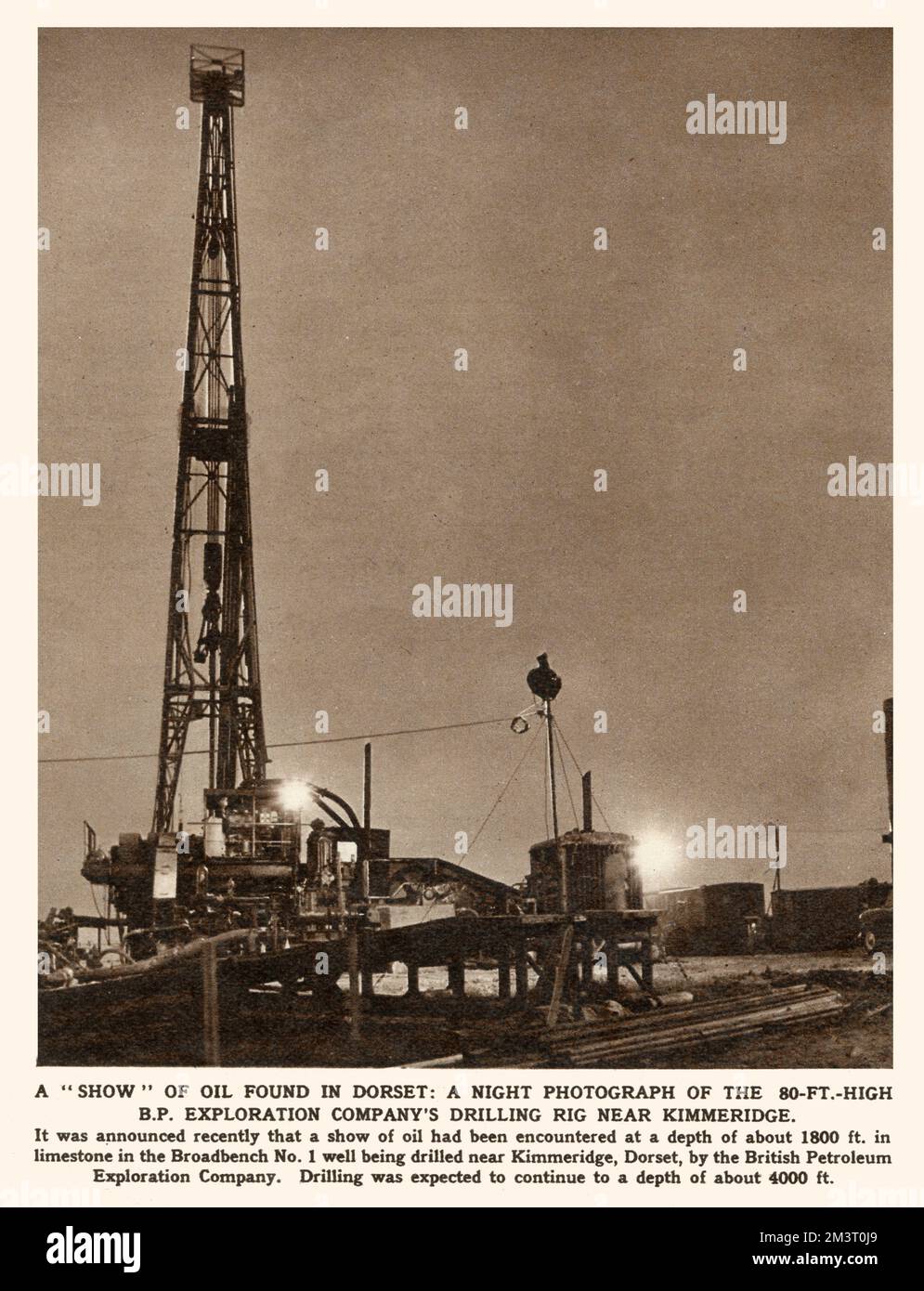 Night photograph of the 80 ft high B.P. Exploration Company's drilling rig near Kimmeridge in Dorset where a show of oil had been encountered at a depth of about 1800 feet in limestone in the Broadbench No.1 well being drilled.   1959 Stock Photo