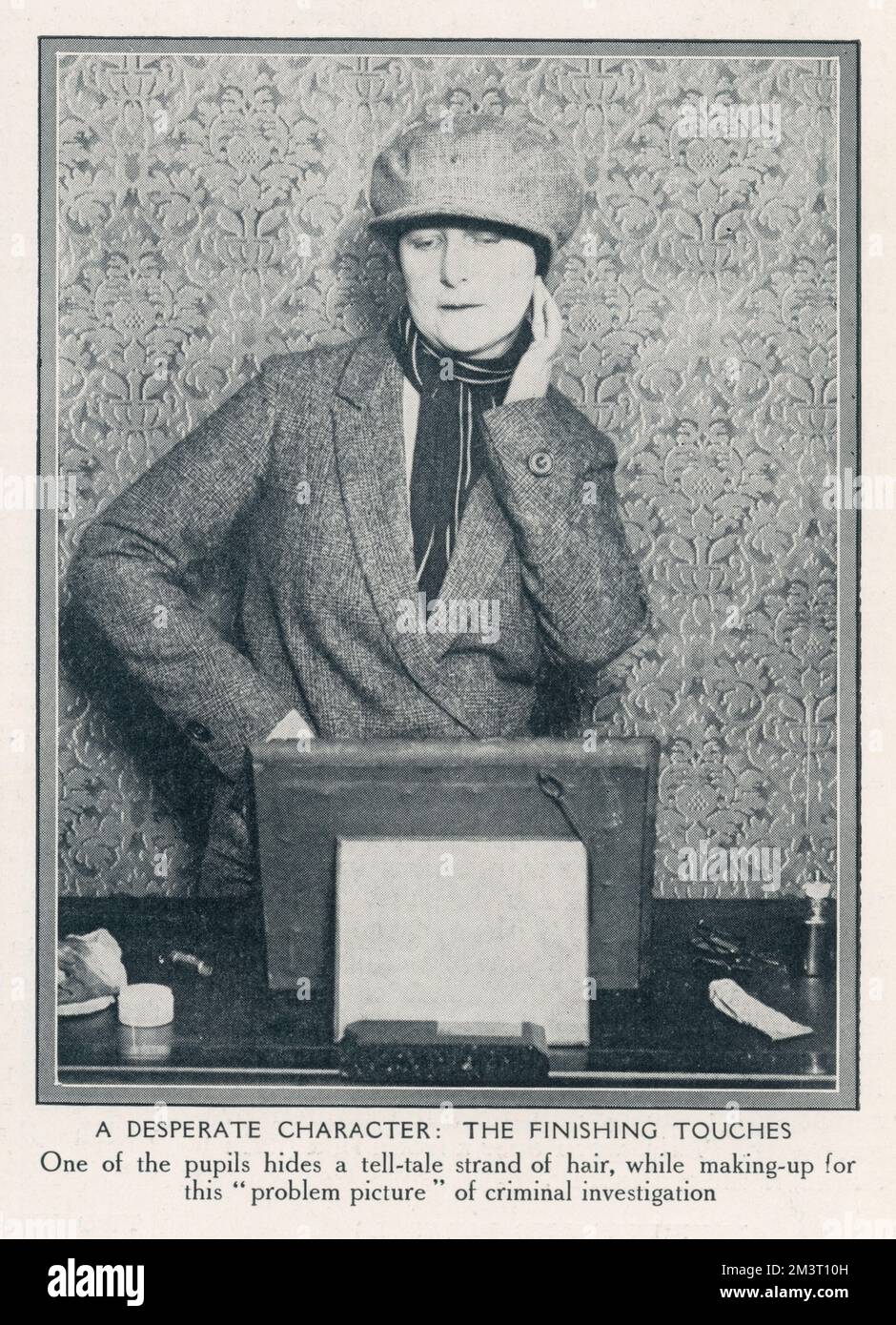 'A desperate character.' A woman detective pupil at the Baker Street school for lady sleuths, run by Mr Kersey, in disguise as a man puts the finishing touches to her character in order to further a criminal investigation. Stock Photo
