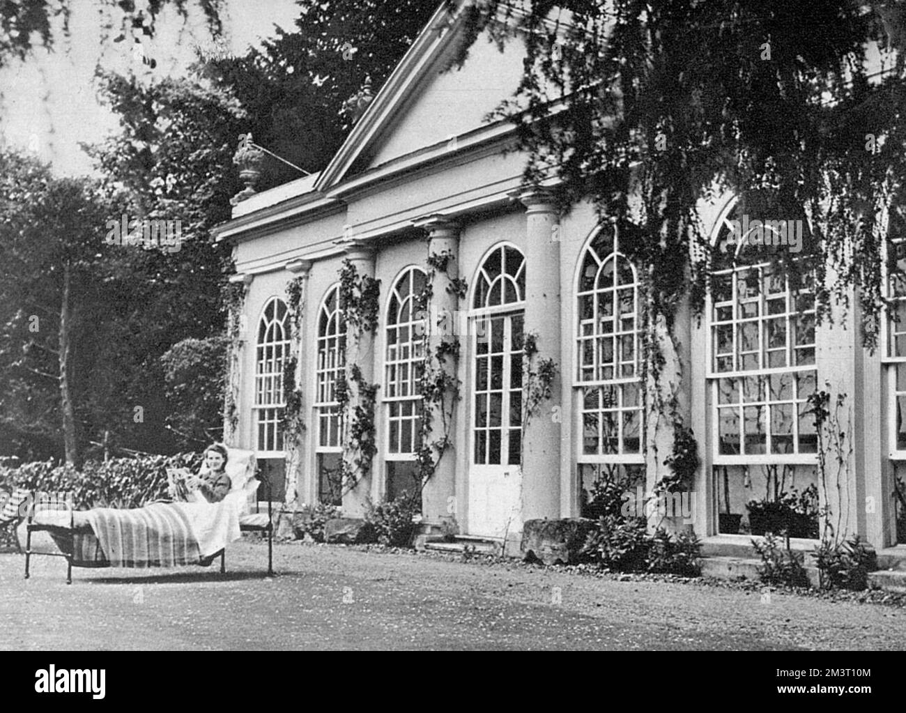 Country Houses in Wartime - Shardeloes, Amersham, Bucks in use a Maternity Home for Evacuee Mothers. The Orangery, dating back to 1790 - Mrs Clark in foreground. Stock Photo
