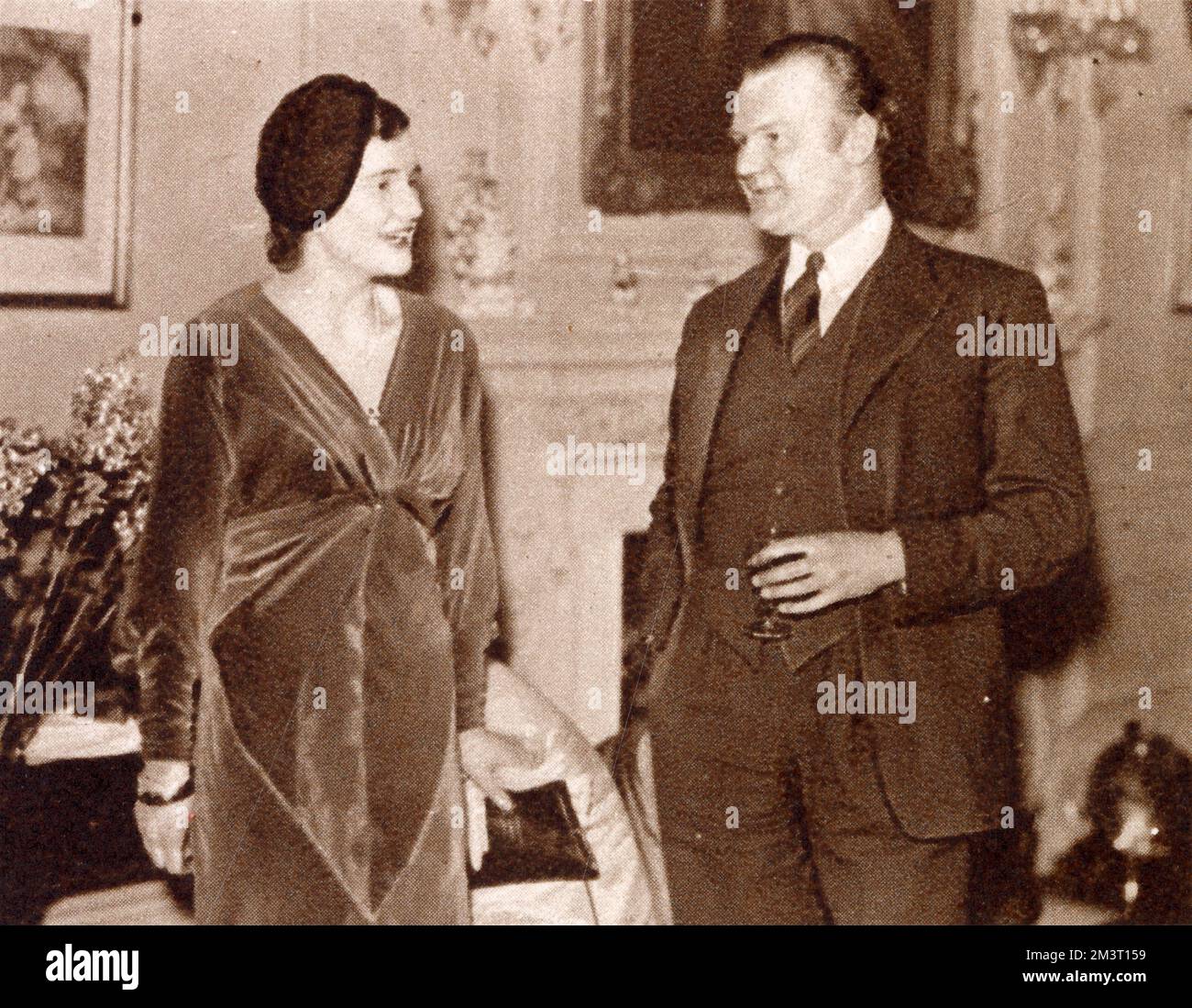 Gordon West talks to Miss Helen Villiers, the younger daughter of Lady Kahleen Villers at a party organised by Lady Hadfield for the Committee and Patrons of Lady Mount Temple's Midnight Matinee (in aid of the Charing Cross Hospital). Stock Photo
