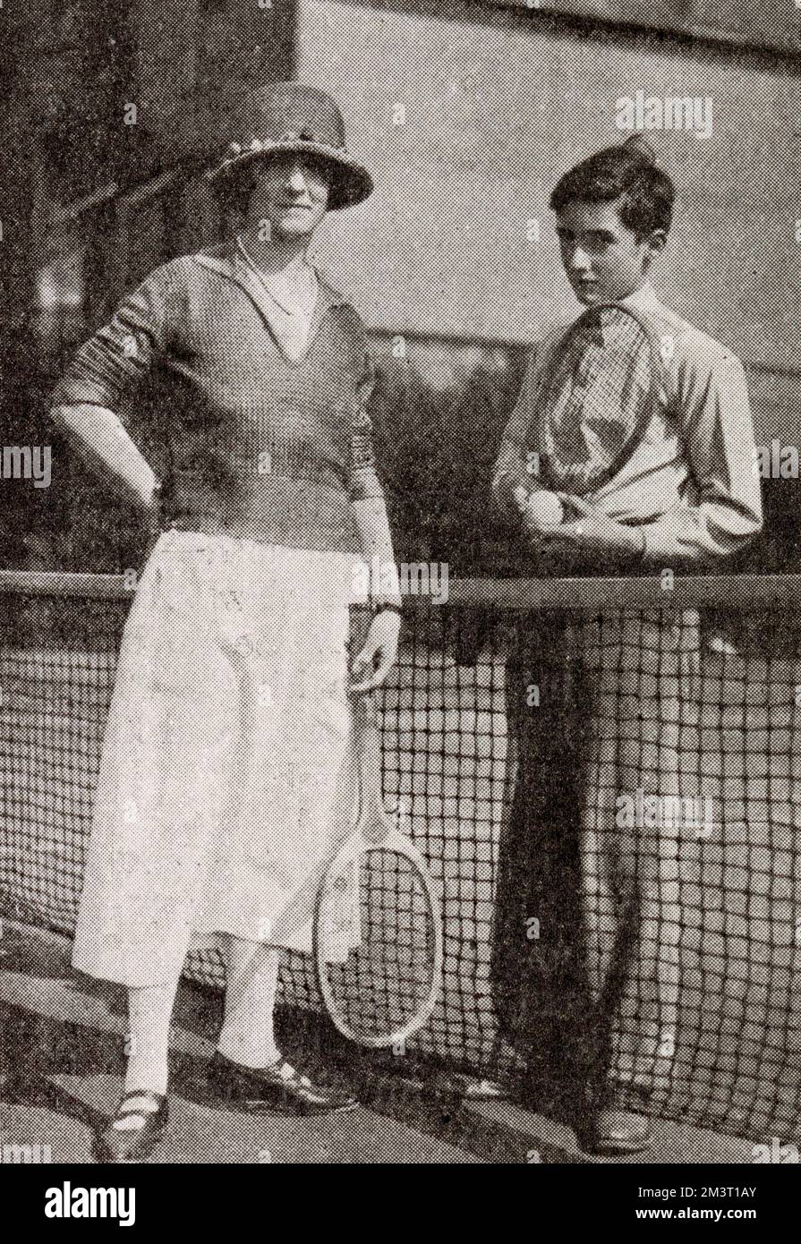 Lady Ennismore, formerly Freda Vanden-Bempde-Johnstone, pictured with her second son, the Hon. Richard Hare (1907-1966), on a tennis court, probably at Queen's Club. Stock Photo