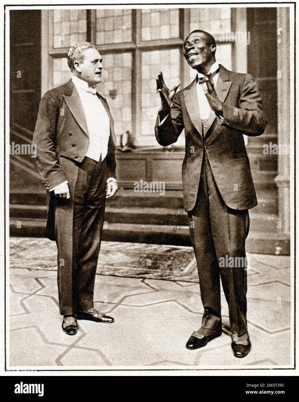 'The Dippers' at the Criterion - a farce by Ben Travers - Mr Ernest Trimmingham (1880 - 1942) is the leader of the band playing for the Dippers. Here he is showing Mr Cyril Maude (in the role of Mr Henry Talboyes) how how to get the hang of syncopated technique. Trimmingham was an actor on stage and screen from the British Overseas Territory of Bermuda. He was one of the first black actors in British cinema.     Date: 1922 Stock Photo
