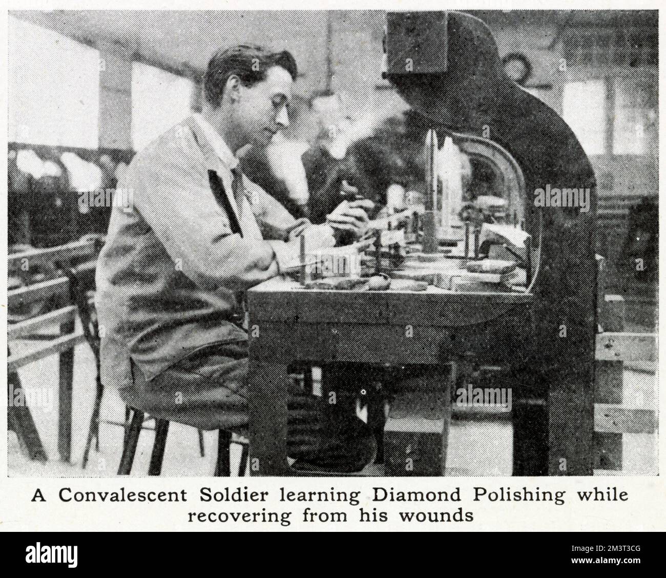 Learning diamond-polishing while recovering from wounds, a convalescent soldier at work. A pilot scheme was started in spring 1917 by Mr. Bernard Oppenheimer, a diamond merchant. The factory provided training for thousands of wounded ex-soldiers and sailors during and after World War One. Stock Photo