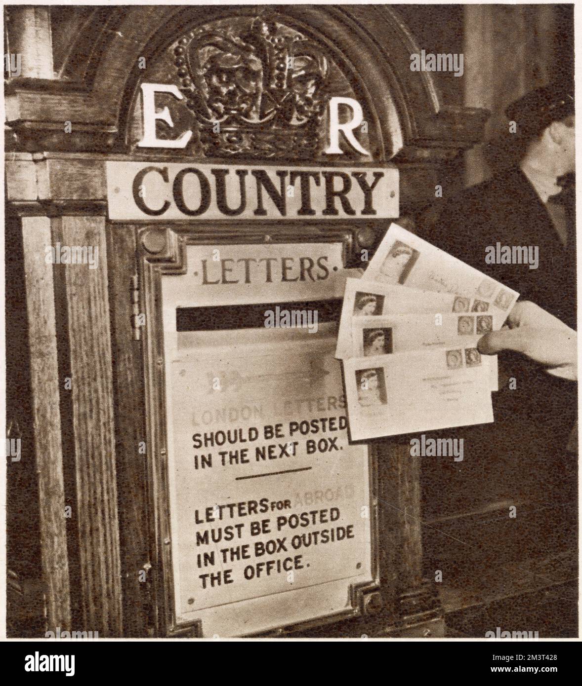Some of the first letters to bear the stamps of the new reign of Queen Elizabeth II being posted at the General Post Office in London, just after midnight on December 5 1952, in special envelopes. Stock Photo