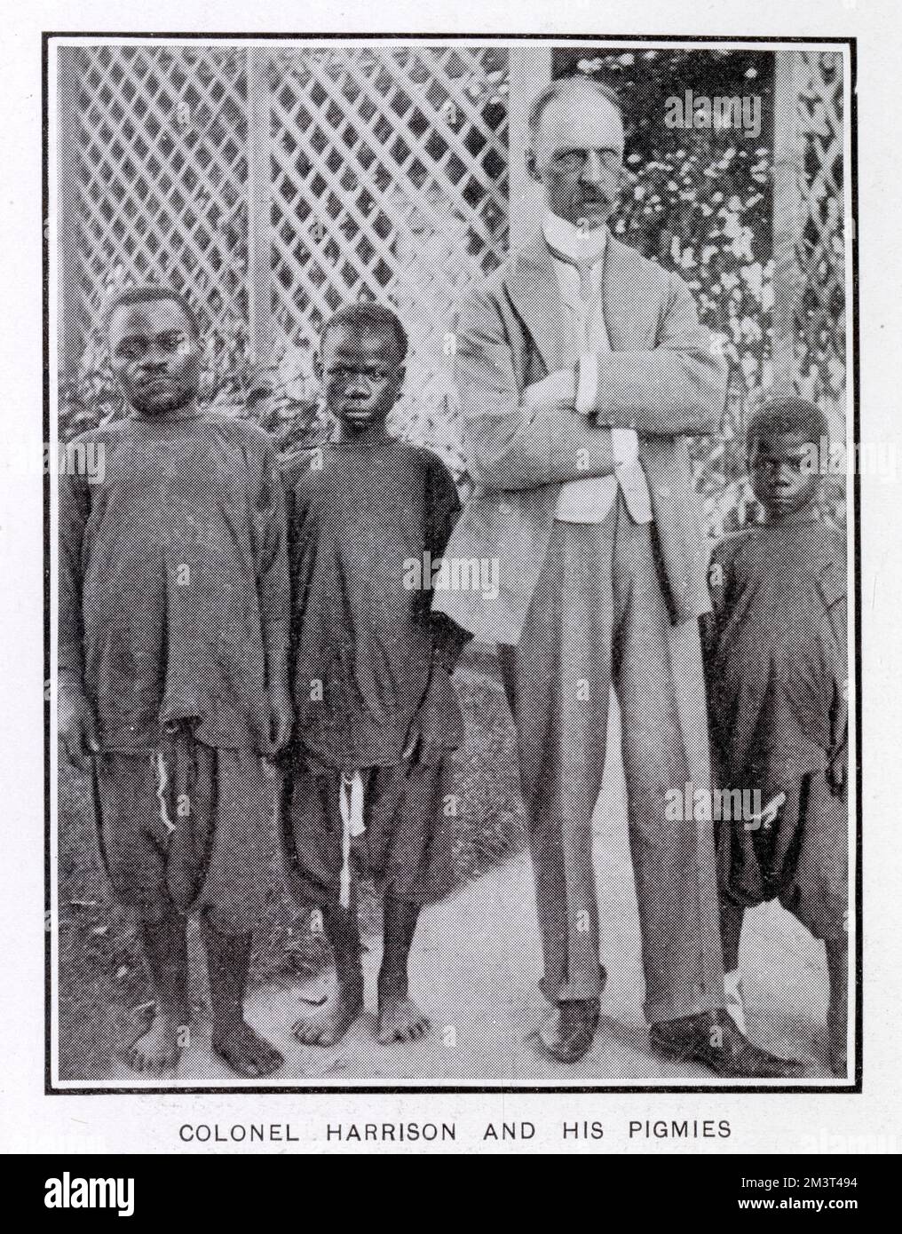 Colonel Harrison pictured with three of the six pigmies from the Ituri Forest in central Congo. In 1905, they were brought to the UK by Harrison of Brandeston Hall, E. Yorkshire and after their 14-week run at the Hippodrome, toured around the country, staying with Harrison in Yorkshire in between times. They returned to the Congo after two years.      Date: 1905 Stock Photo