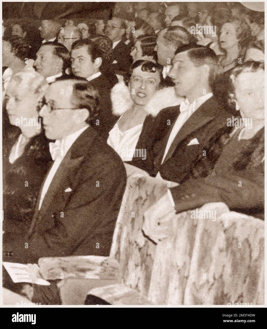 Dorothy Gladys (Dodie) Smith (1896 - 1990), English novelist and playwright, author of the plays 'Autumn Crocus' and 'Dear Octopus' and the books, 'I Capture the Castle' and 'One Hundred and One Dalmatians'. Pictured at the first night of the new Charles Cochran revue, 'Follow the Sun' at the Adelphi Theatre. Seen third from right in the second row. Stock Photo