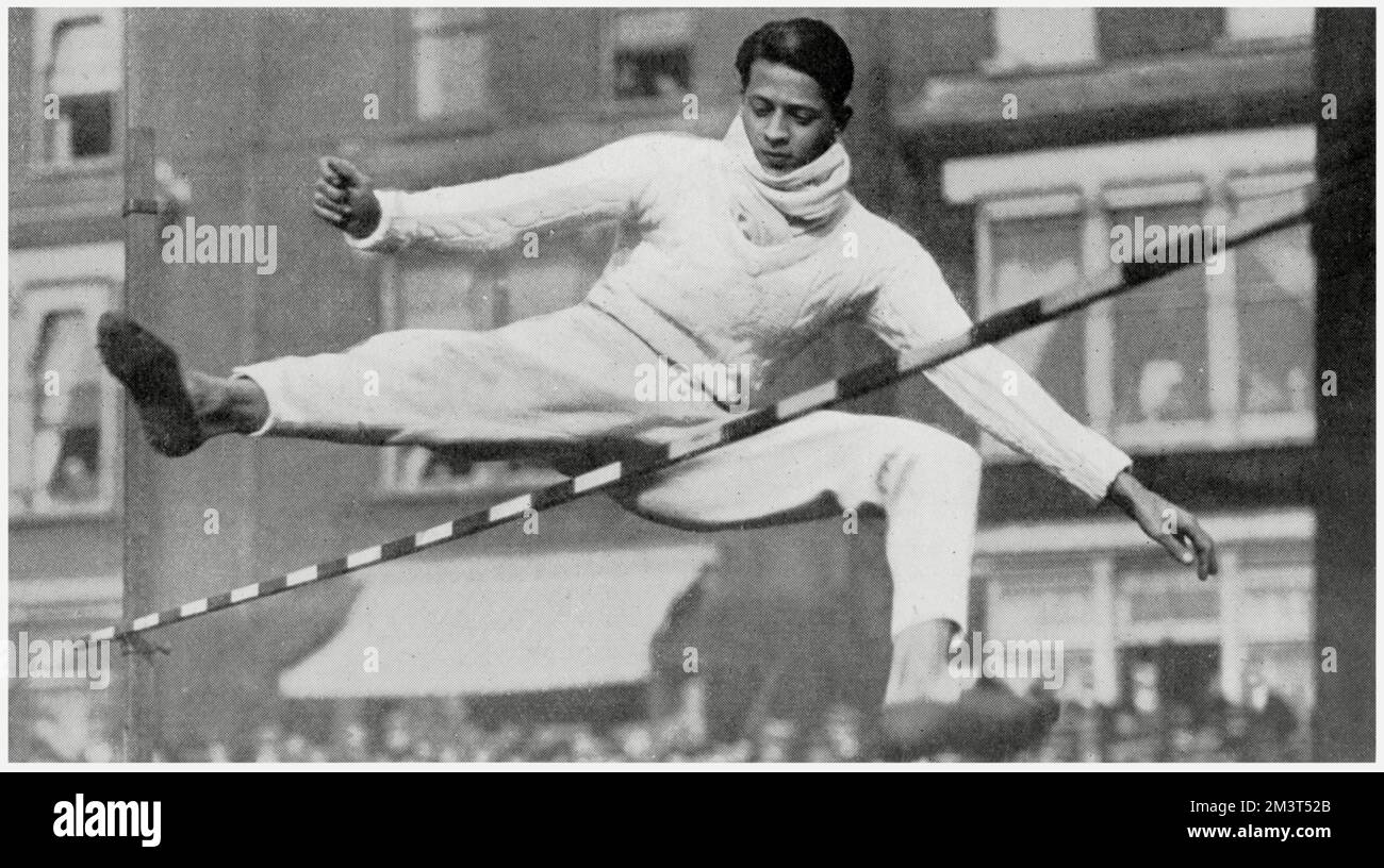 Wearing his flannels and muffler (!) C T Van Geyzel (Cambridge) from Sri Lanka (Ceylon) wins the high jump at the Oxford and Cambridge Meeting at Queen's Club, clearing 5ft, 11 1/2 inches. Stock Photo