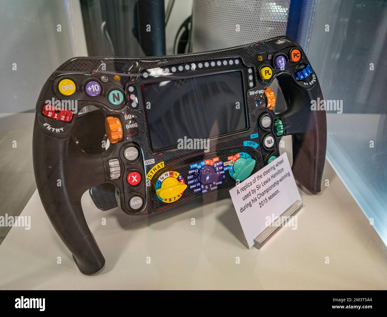 A steering wheel (replica) used by Sir Lewis Hamilton in the 2015 season  inside Mercedes-Benz Brooklands, Mercedes-Benz World, Surrey, UK. Stock Photo