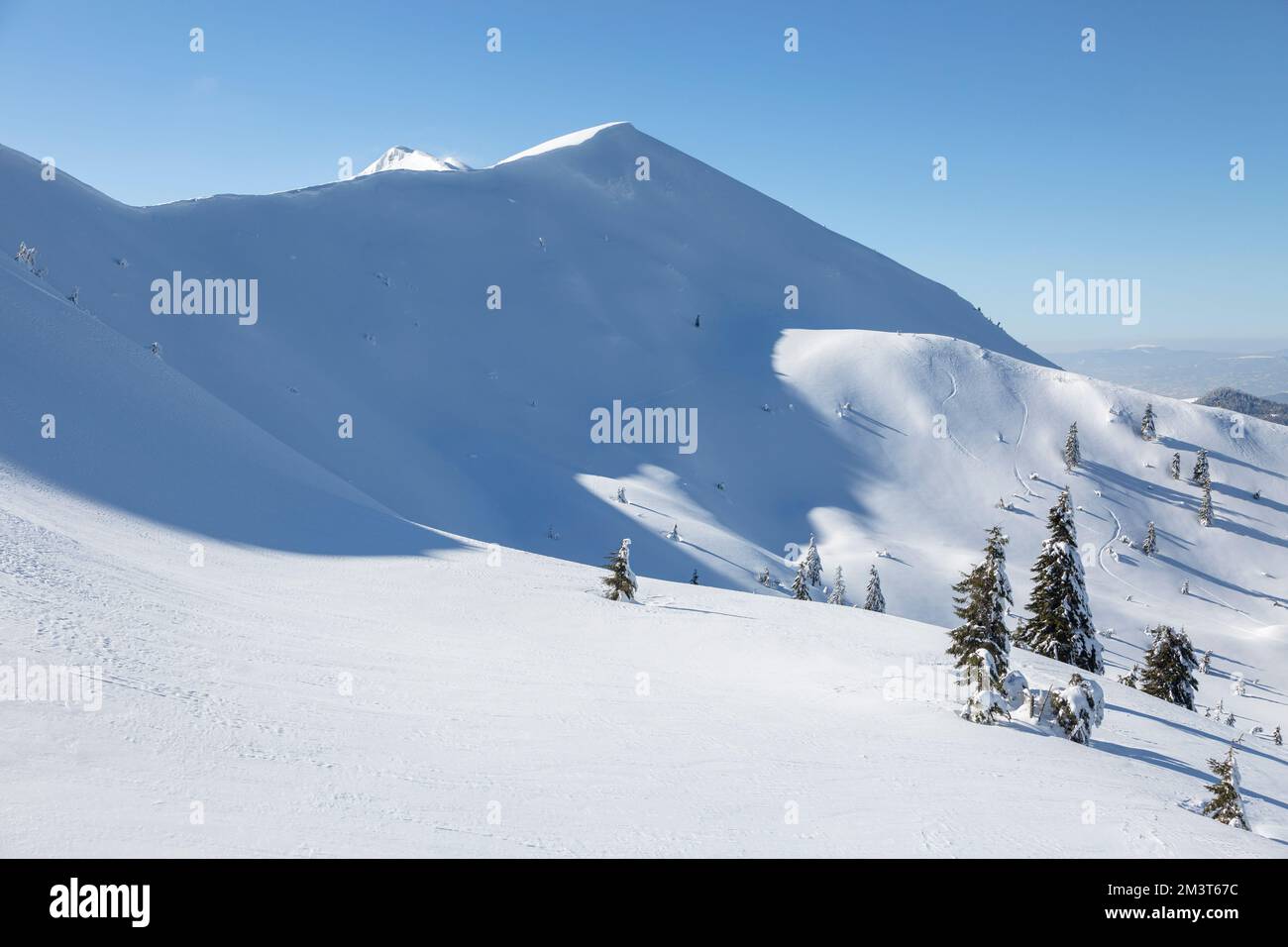 The sharp peaks of the mountains are covered with white fresh snow ...