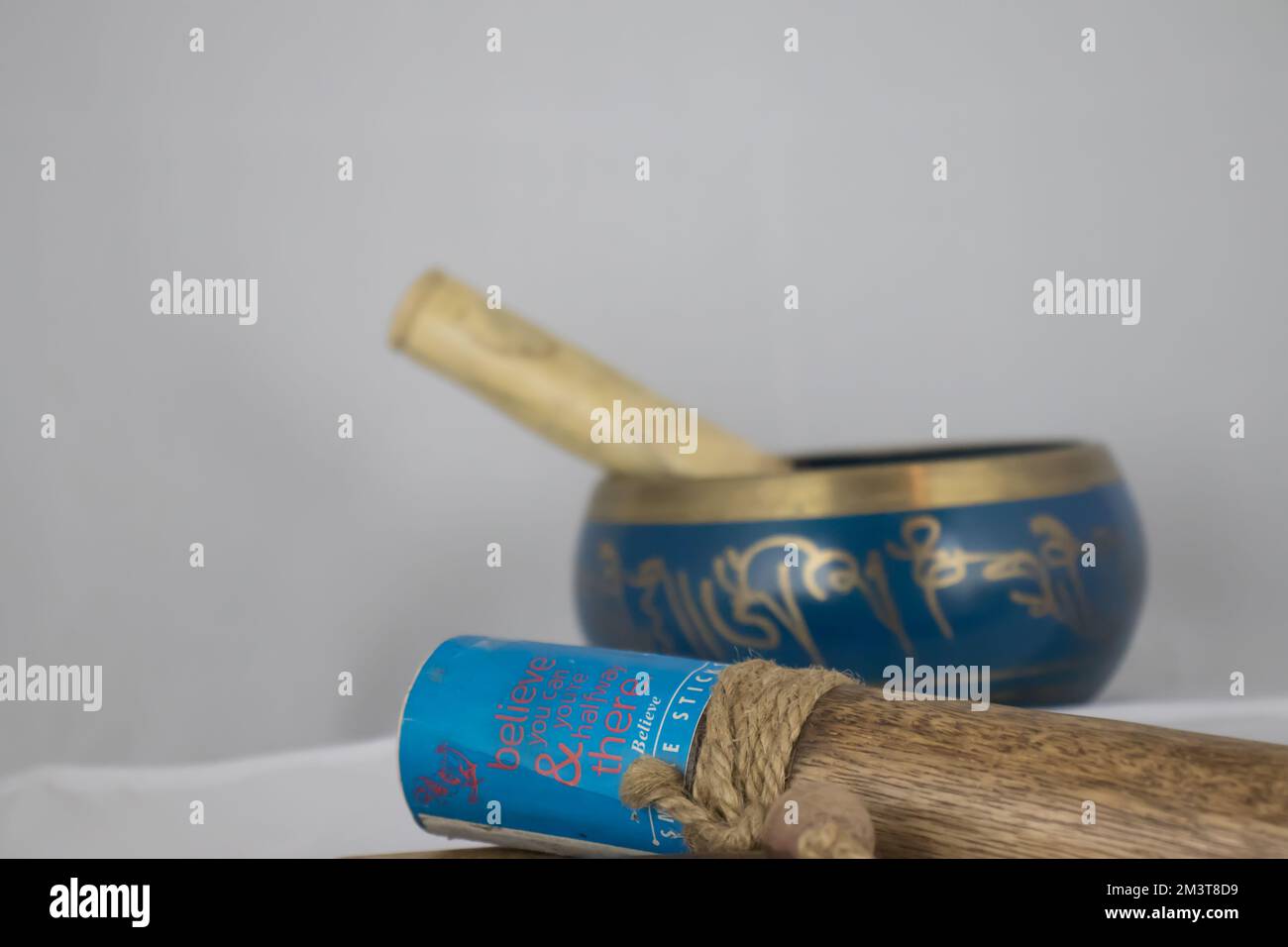 Hand Crafted bronze Indian Singing Bowl painted in Blue and Gold color, often used in Hindu