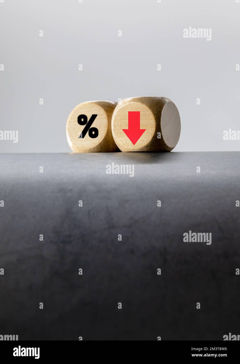 'Interest, Up, Down' wooden block with arrows, The concept of wanting interest rates to go down Stock Photo