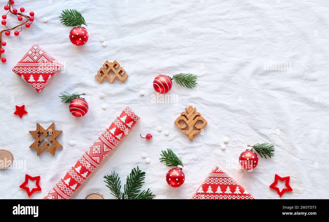 Latvian Yule, Christmas. Ethnographic symbols and patterns from Latvia, wood amulets, wrapping paper, gift boxes with fir tree and berries. Baltic Stock Photo