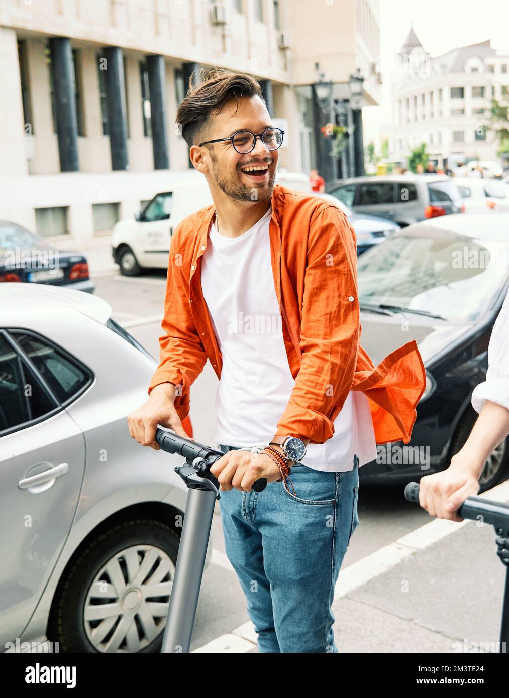 couple young man boy guy electric scooter city transport riding technology lifestylestreet friend driving modern Stock Photo
