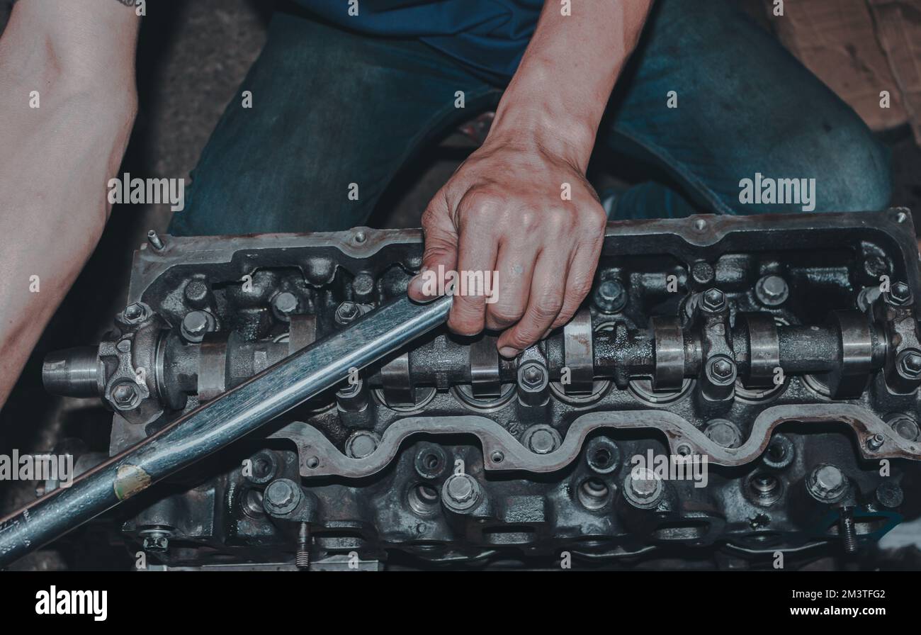 A closeup of a mechanic fixing an internal combustion engine Stock