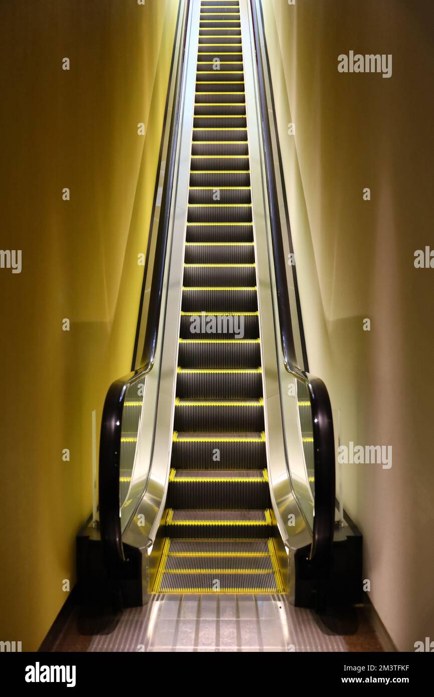 A single escalator filled with light Stock Photo - Alamy