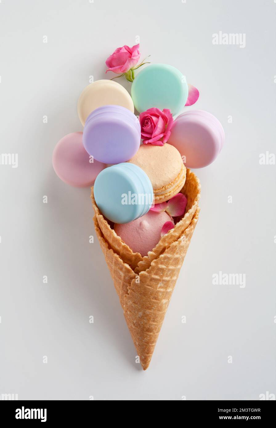 Photo of color containers for cosmetic products in waffle cone on the white table Stock Photo