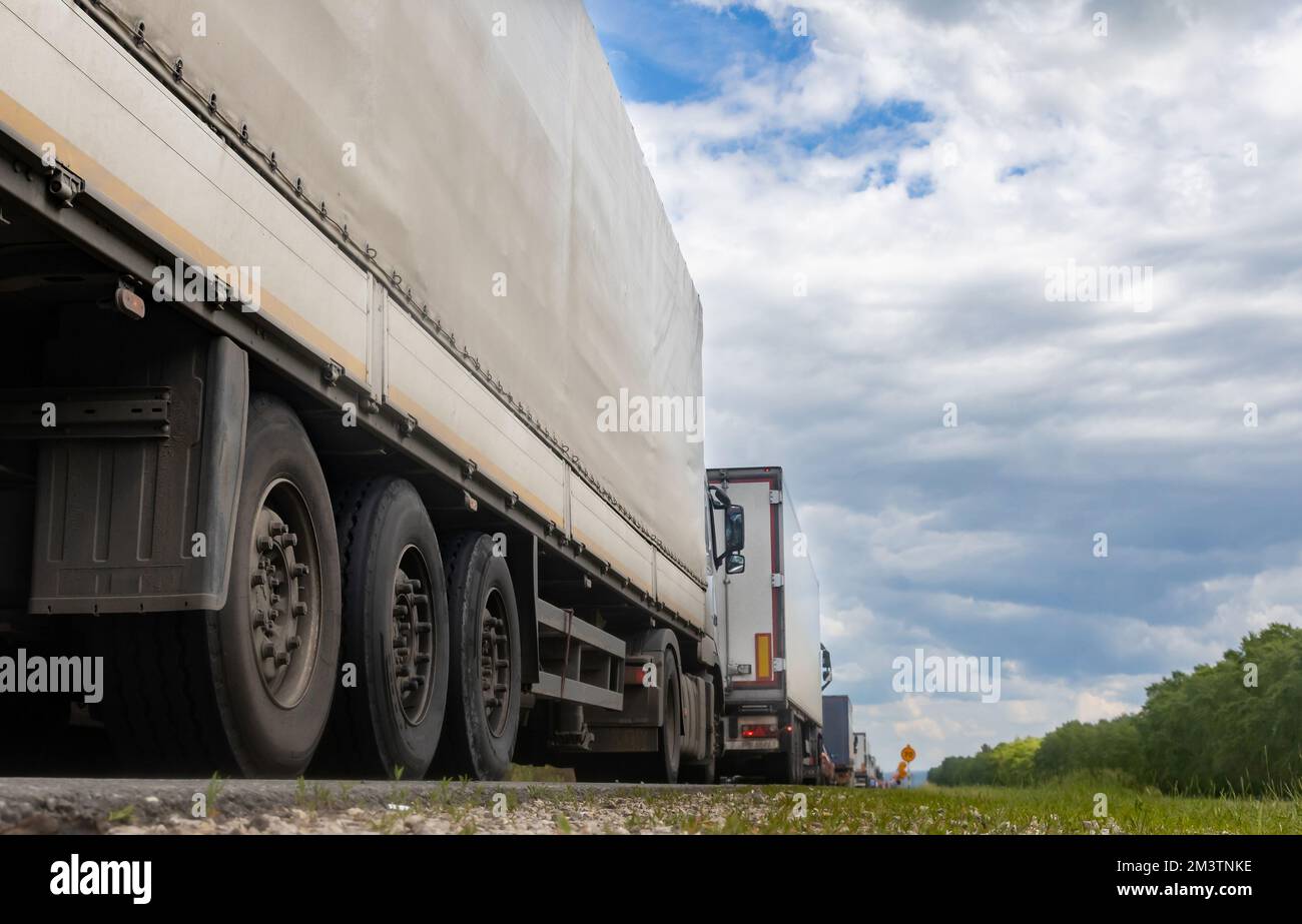 Trucks are stuck in traffic. A column of semitrailers on the freeway
