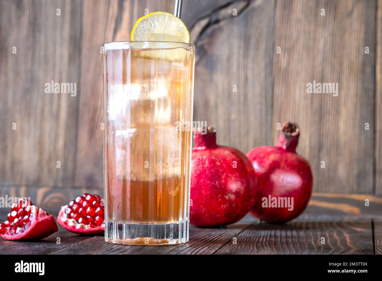 The Moment cocktail in collins glass garnished with lemon wheel Stock