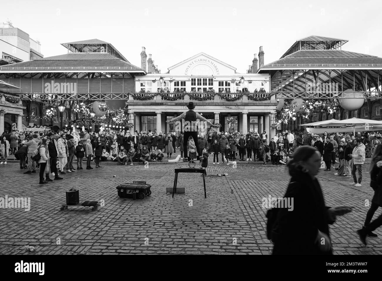 A street performer entertaining the public at Covent Garden, London, United Kingdom. Black and white photo. Stock Photo