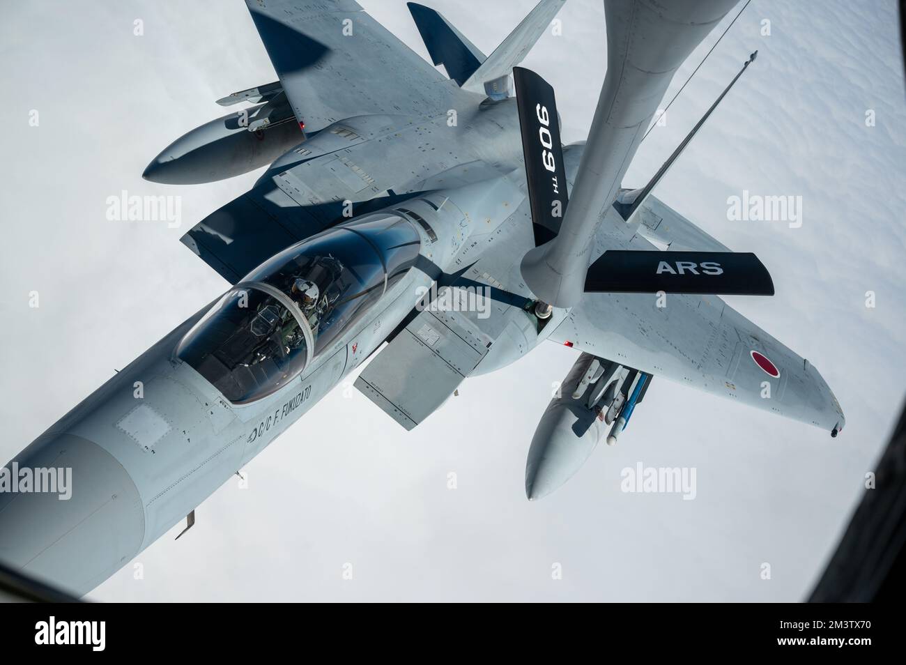 A Japan Air Self-Defense Force F-15J Eagle receives fuel from a U.S. Air Force KC-135 Stratotanker assigned to the 909th Air Refueling Squadron over the Pacific Ocean, Dec. 14, 2022. Shared security and stability depends on strong, capable networks of Alliances and partnerships. (U.S. Air Force photo by Senior Airman Yosselin Campos) Stock Photo