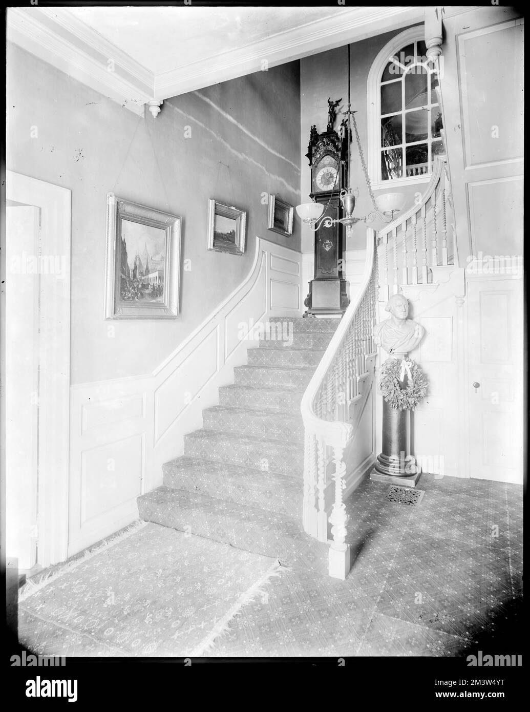 Staircase, unidentified interior with grandfather clock and bust of Washington , Stairways.  Leon Abdalian Collection Stock Photo