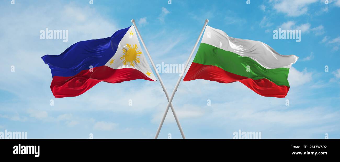 two crossed flags Bulgaria and Philippines waving in wind at cloudy sky ...