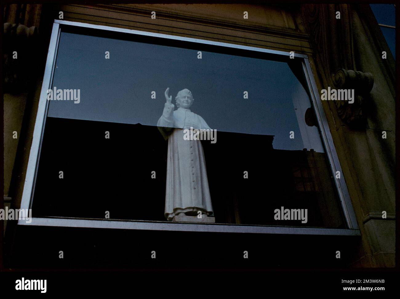 Statue of priest behind a window, Boston , Sculpture, Priests. Edmund L. Mitchell Collection