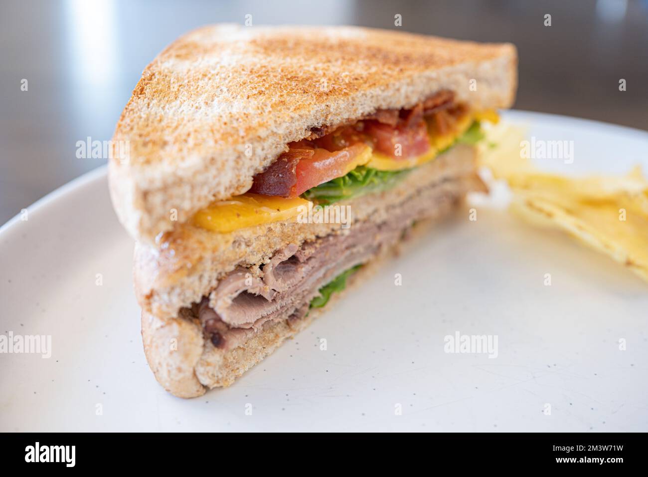 Toasted Texas Club Sandwitch ready to eat with crisps Stock Photo