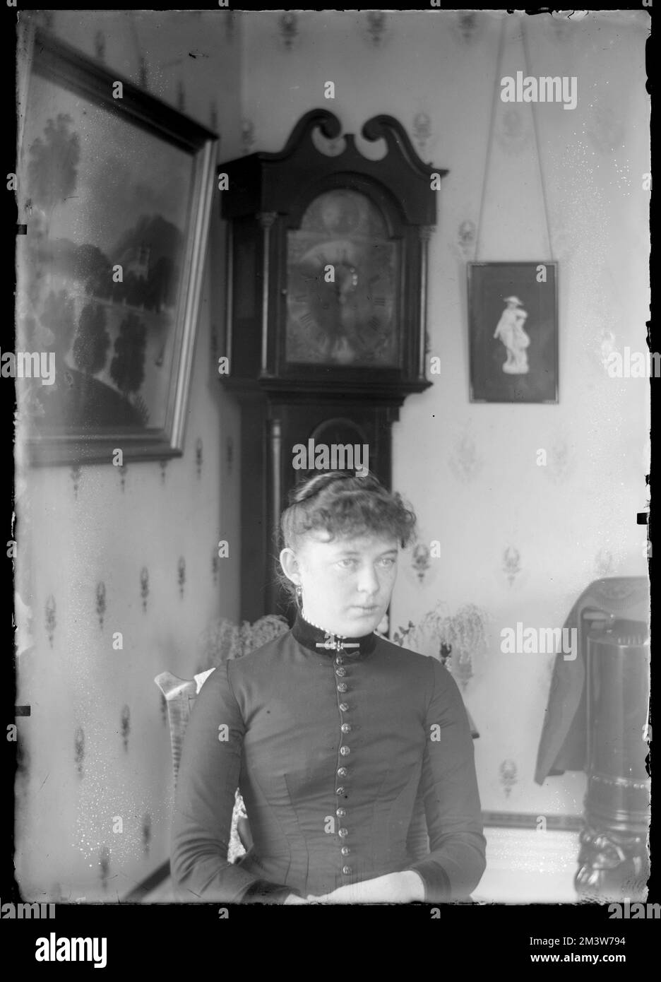 Stella Good sitting in front of grandfather clock , People. Hingham Public Library Glass Slide Collection Stock Photo