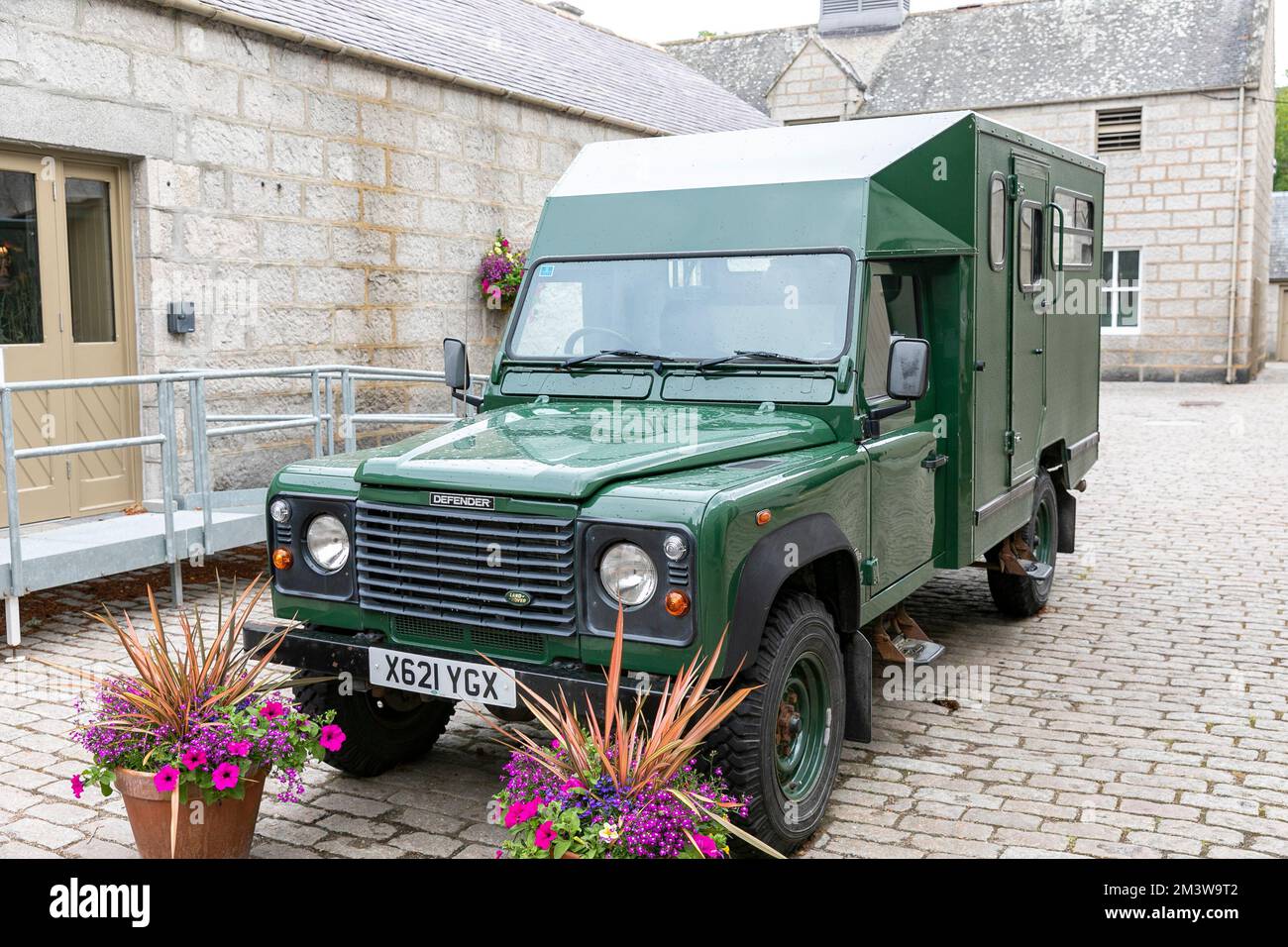 Balmoral Castle grounds and green modified Land Rover Defender part of the Queen Elizabeth 11 fleet of cars vehicles Stock Photo