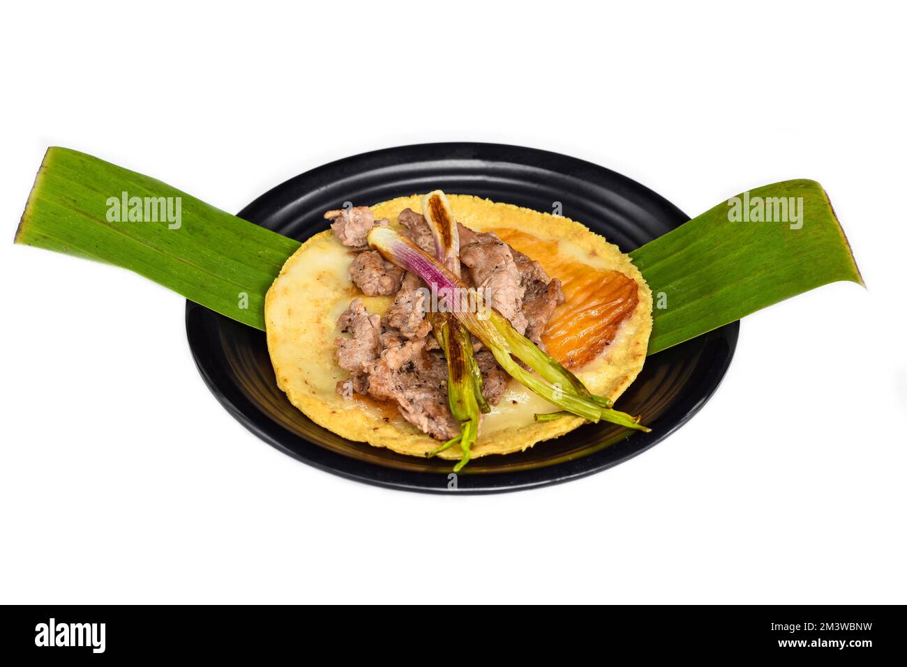 Tacos Zocalo steak with grilled cheese on black plate isolated on white background  top view Stock Photo