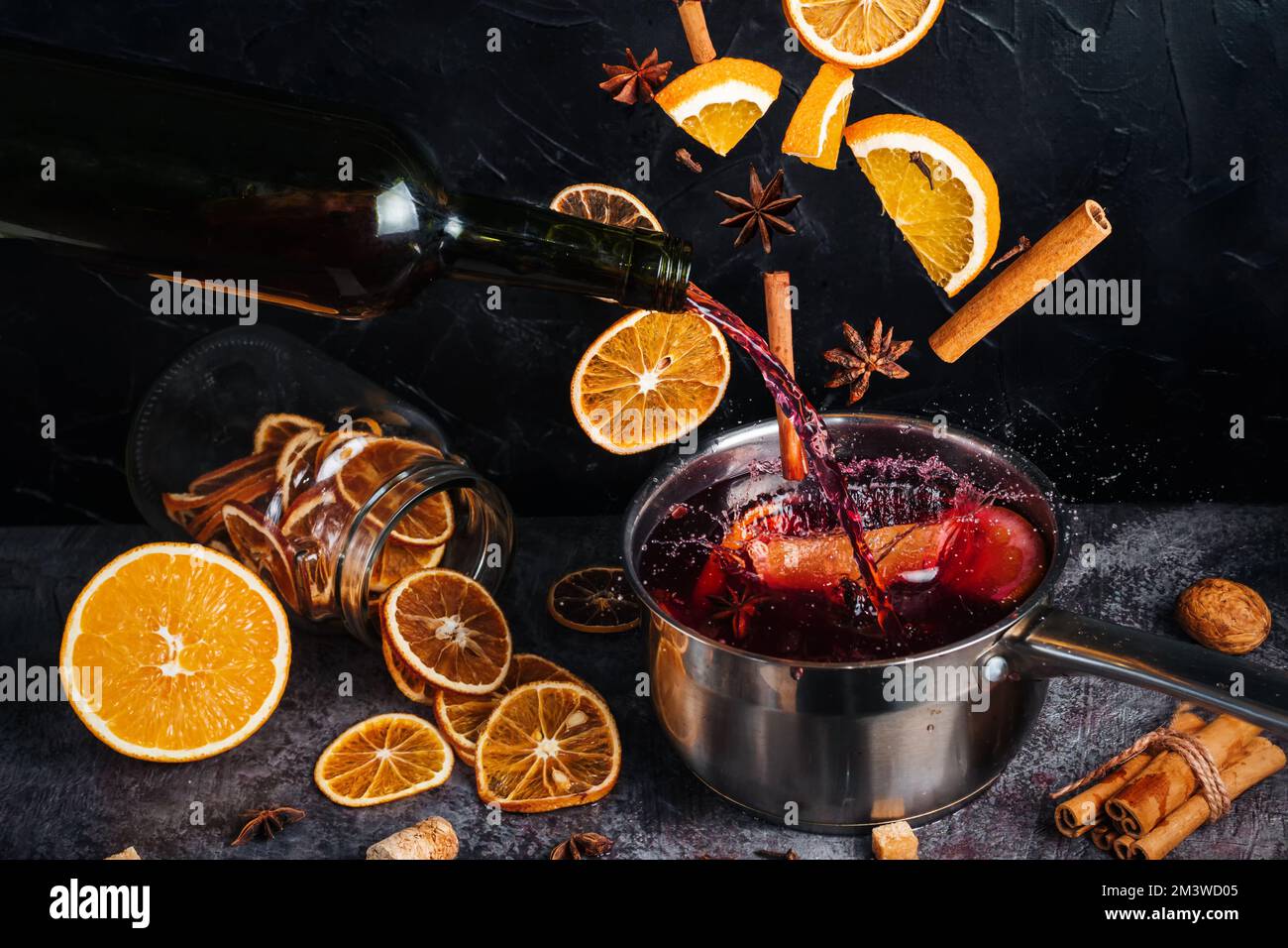Falling mulled wine ingredients, citrus fruits, cinnamon and star anise fly from a height and