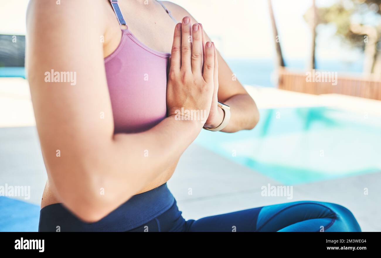 Make peace with yourself. an unrecognizable woman practicing yoga outdoors. Stock Photo