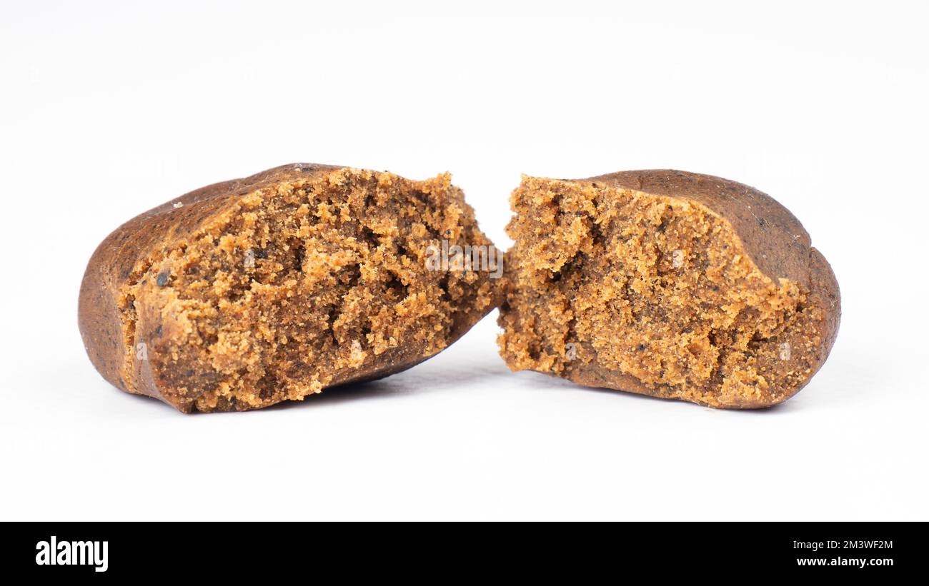 brown broken piece of cannabis concentrate hashish isolated on white background, hash weed. Stock Photo
