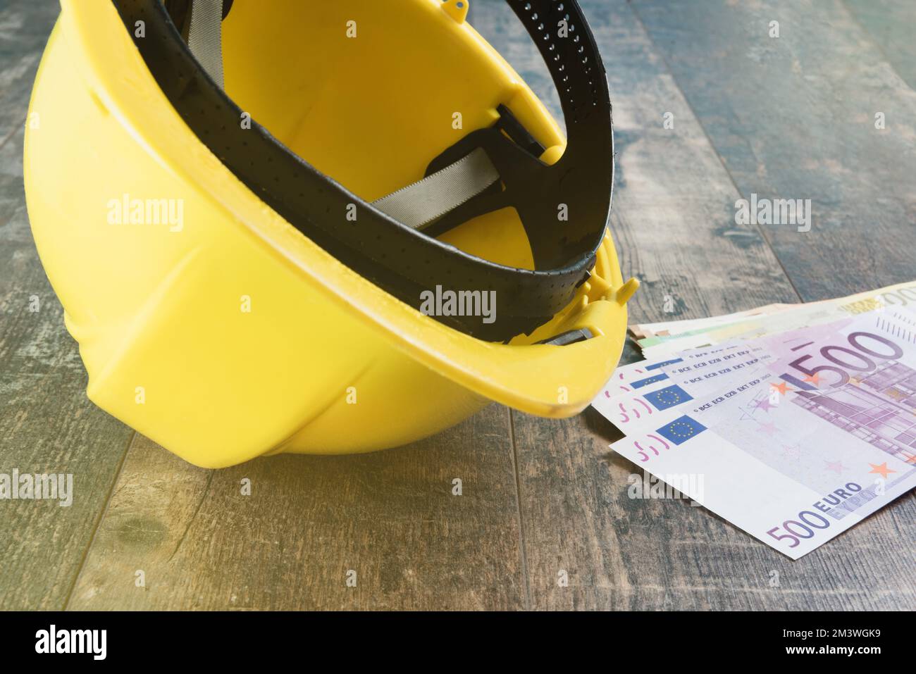 investment construction budget  Euro money banknotes and yellow construction helmet Stock Photo