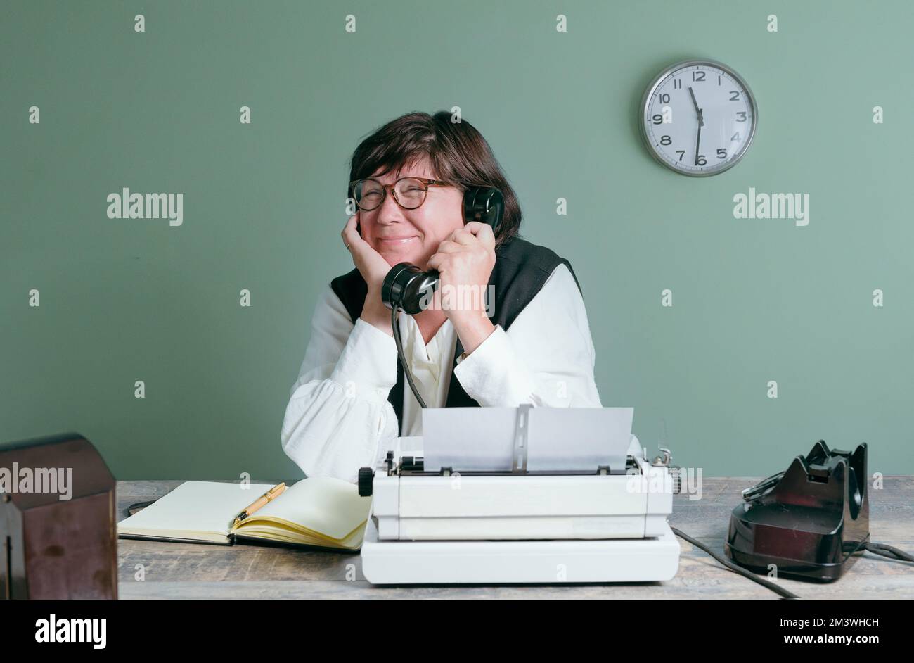Talking on the phone while working. Secretary woman from the past Stock Photo