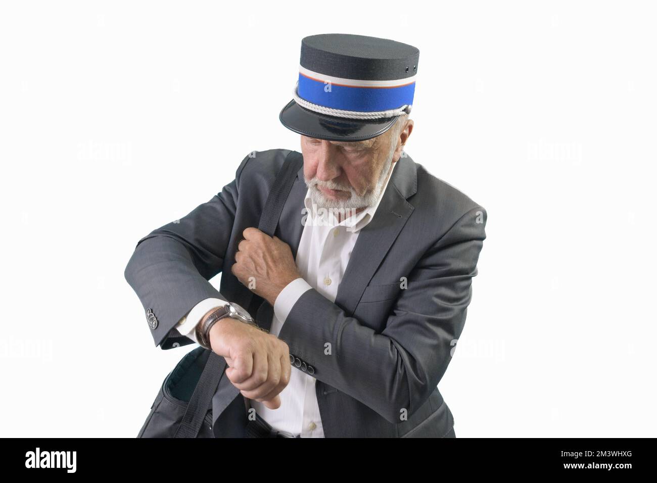 The train conductor looks at his wristwatch while waiting for the train to depart. Isolated. On a white background. Stock Photo