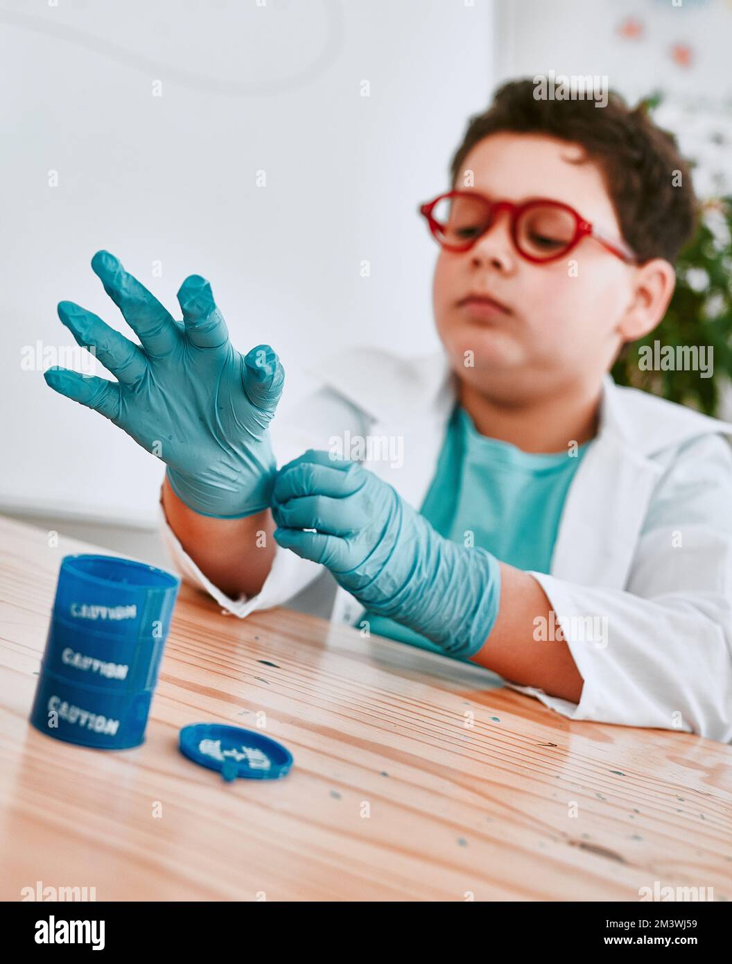 Lets get down to work. an adorable young school boy putting on