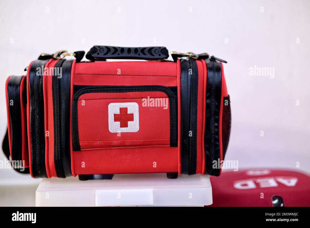 First aid kit bag and AED emergency equipment on white background Stock
