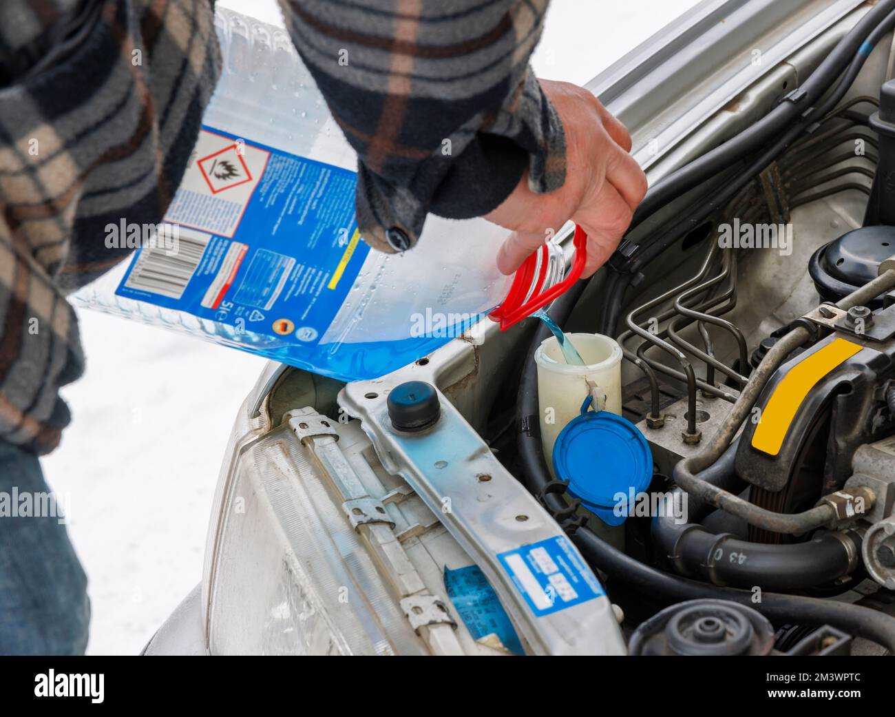 Man, put antifreeze in the car Stock Photo Alamy