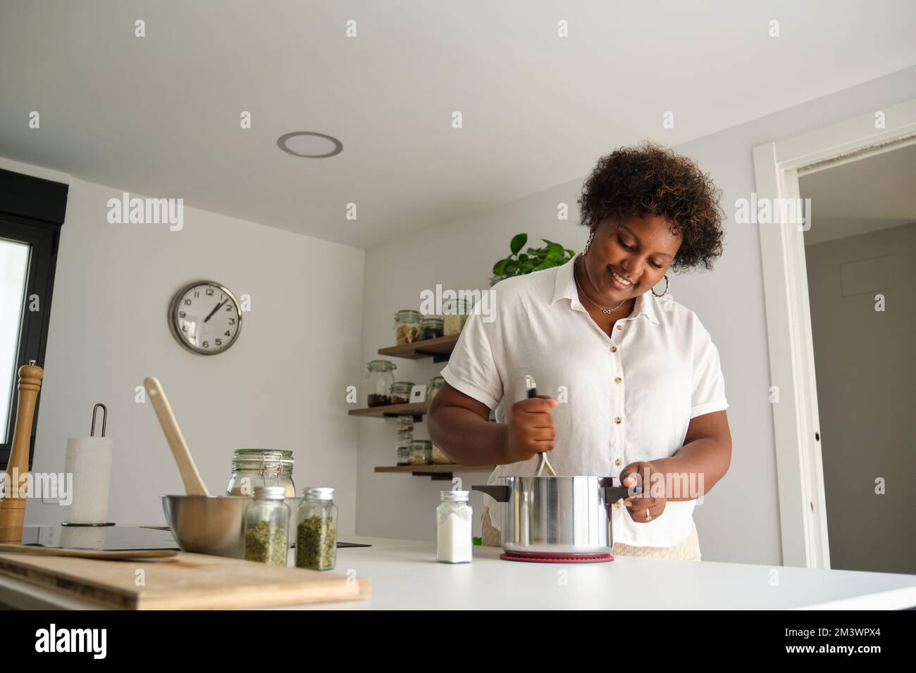 Young cuban woman mashing potatoes Stock Photo Alamy