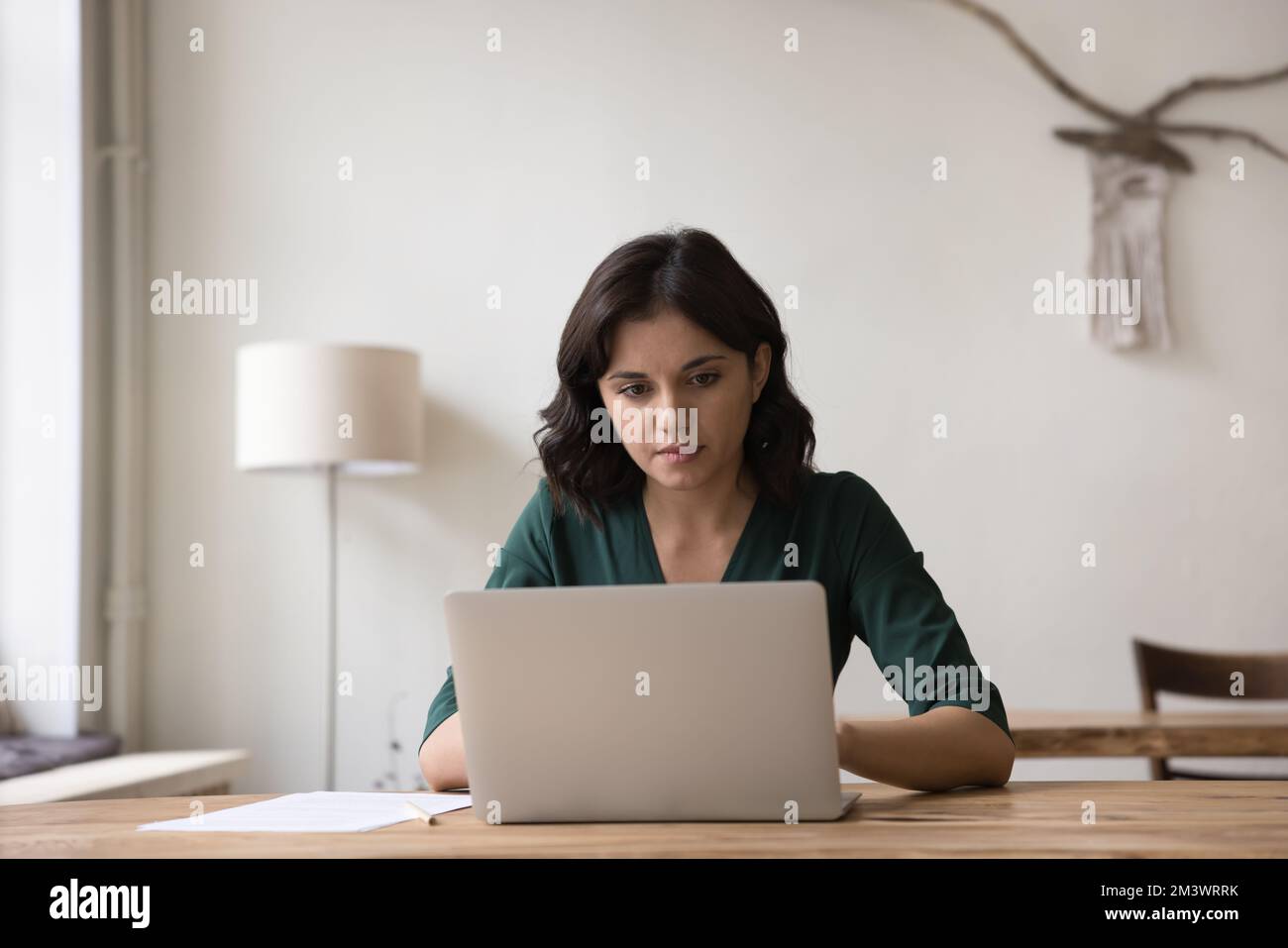 Serious Asian freelance entrepreneur woman using laptop computer Stock Photo