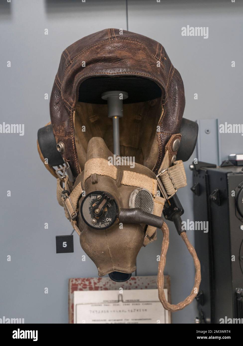 A World War II flying helmet with fitted earphones and microphone on display at the Brooklands Museum, Surrey, UK. Stock Photo