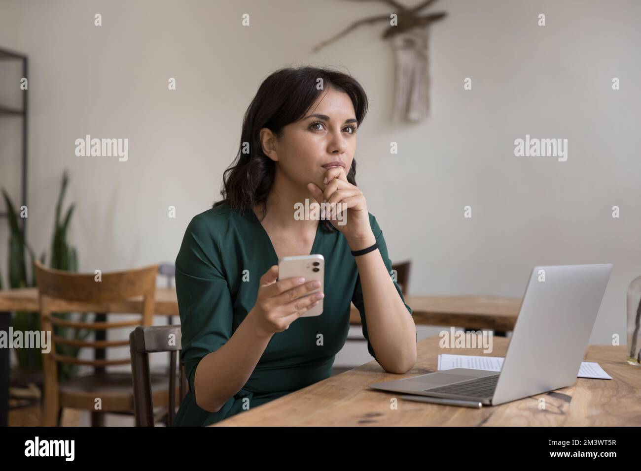 Serious pensive employee woman thinking over online project Stock Photo
