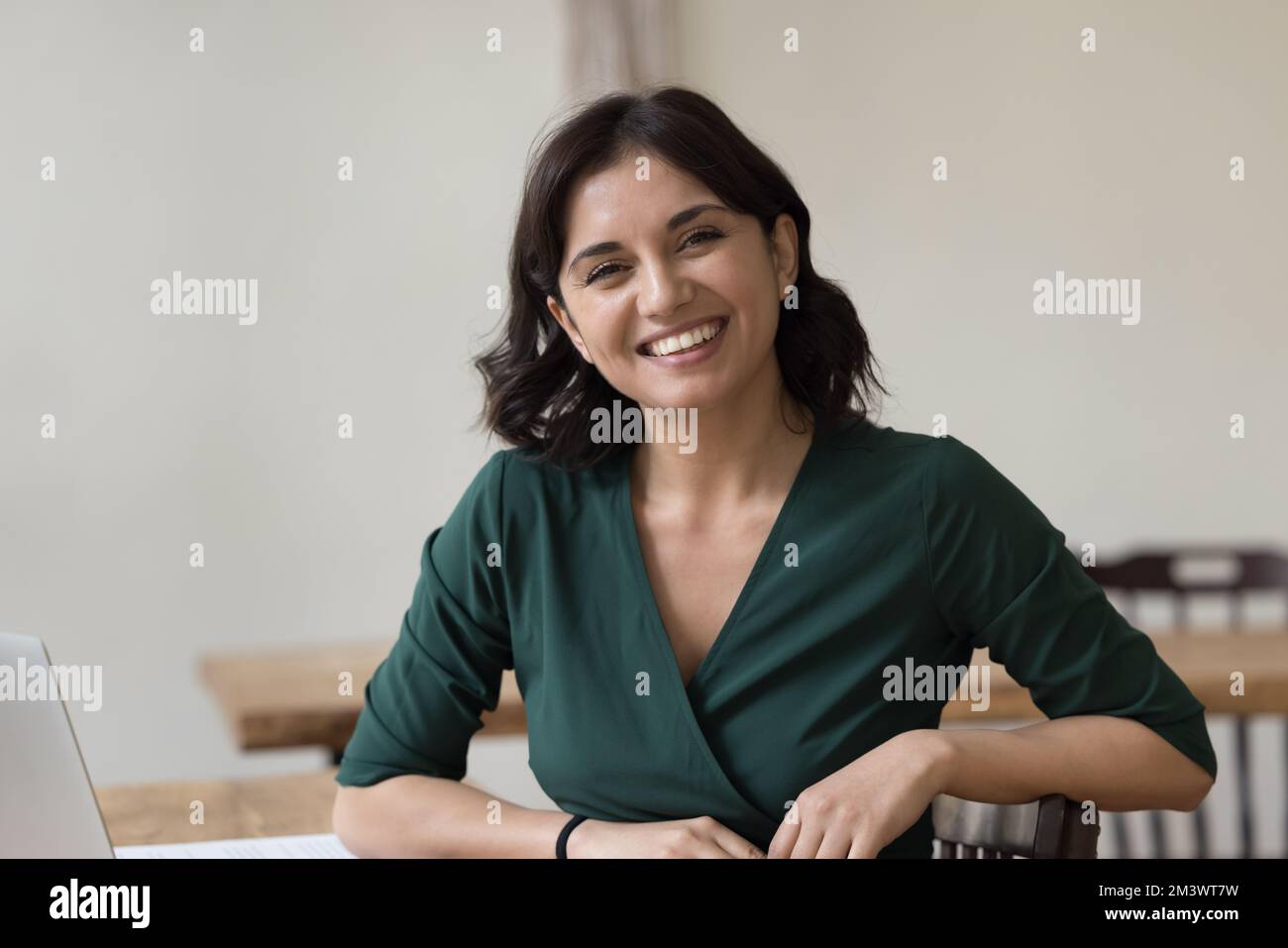 Happy successful business woman sitting at work table Stock Photo