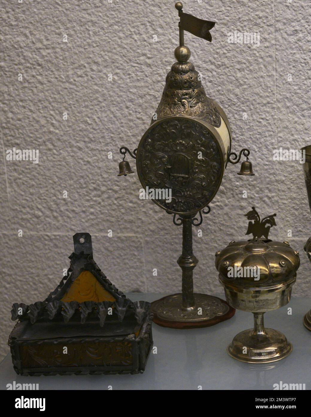 Left: lamp for the festival of Lights (Hanukkah). Late 19th century. Brass and glass. From Djerba (Tunisia). Center: perfumer for the Habdalah ceremony. 19th-20th centuries. Silver and ivory, inscriptions in Hebrew. From Central Europe. Right: Kiddush cup for the Sabbath feast with lid and spice container. Hebrew inscriptions. 20th century. Silver. From Central Europe. Sephardic Museum. Toledo. Castile-La Mancha. Spain. Stock Photo